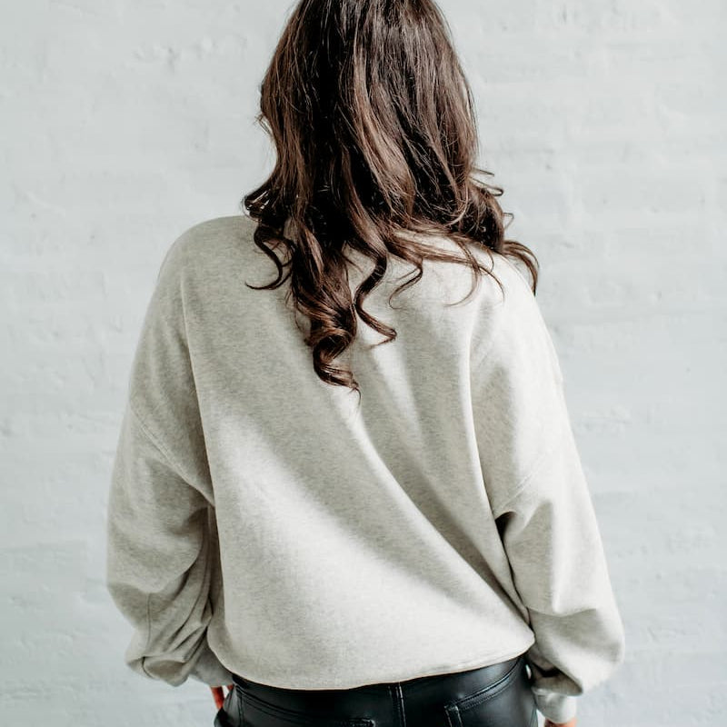 Back view of the oatmeal heather Purdue Boilers Slouchy Crewneck showing the relaxed drop-shoulder silhouette and plain back.