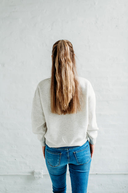 Back view of a model wearing the Iowa State Football Slouchy Drop Shoulder Crewneck in oatmeal heather.
