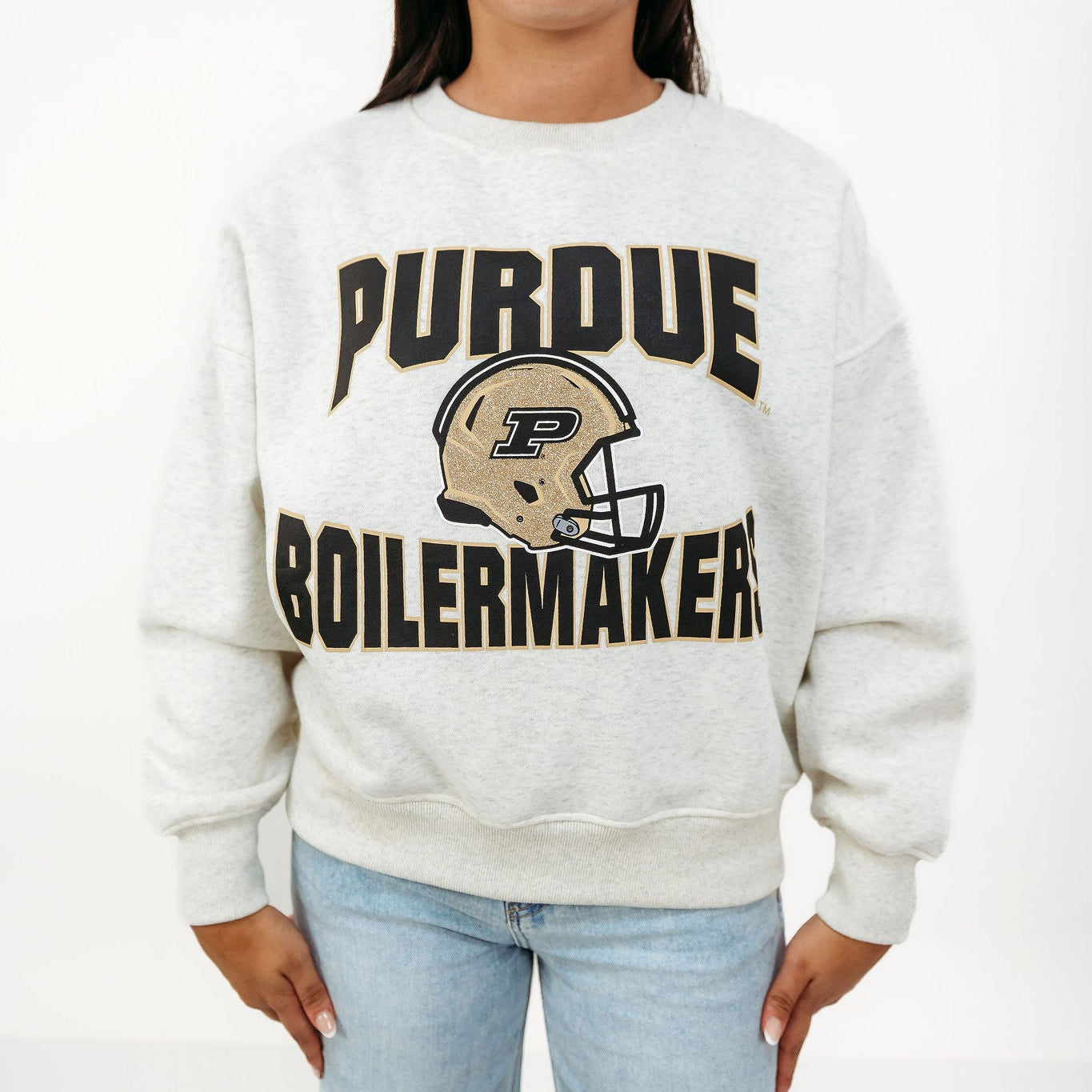 Close-up of the Purdue Boilermakers Football Drop Shoulder Crewneck featuring bold black and gold lettering with a gold Purdue football helmet graphic.