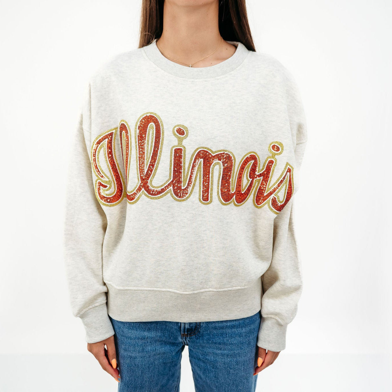 Close-up of the vintage-inspired Illinois sequin graphic on the slouchy drop shoulder crewneck.