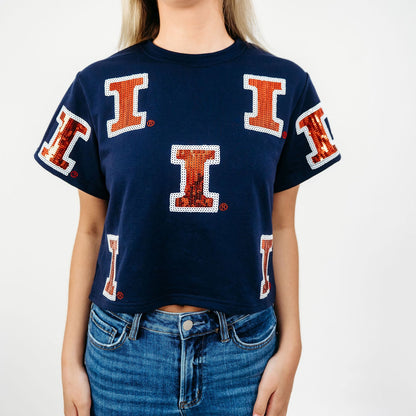 Close-up of the orange and blue full coverage sequin Illinois graphic on the women's game day tee.