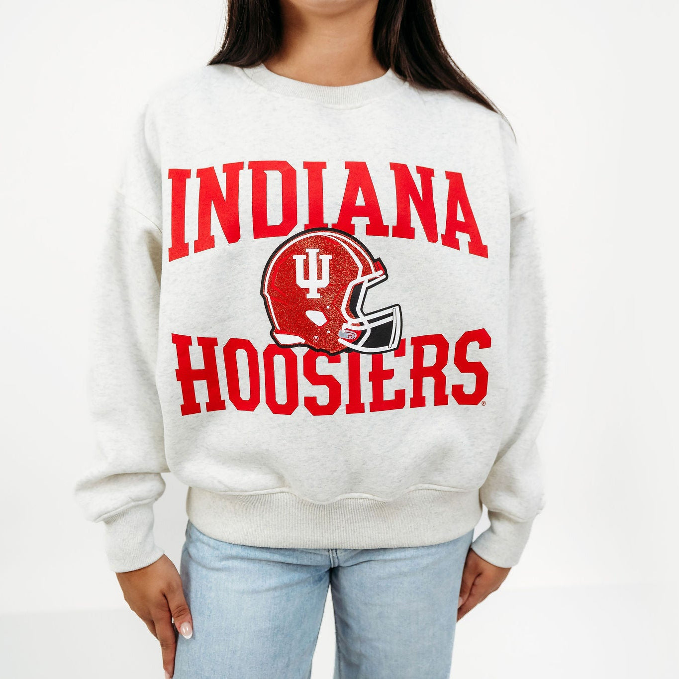 Front view of the Indiana Hoosiers Football Slouchy Drop Shoulder Crewneck in oatmeal heather, featuring red Indiana Hoosiers lettering and a crimson sequin football helmet graphic.
